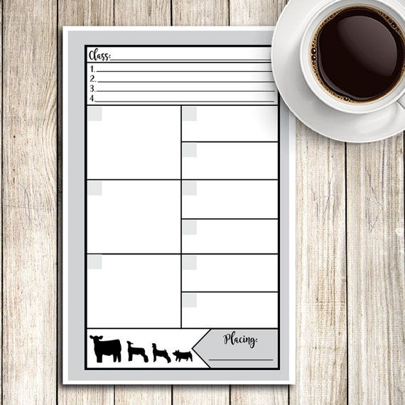 A Cup Of Coffee Sitting On Top Of A Table Next To A Paper With Cows